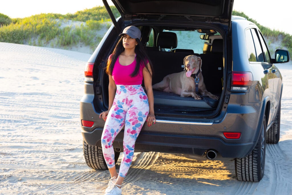 Girl and dog hanging out in back of car